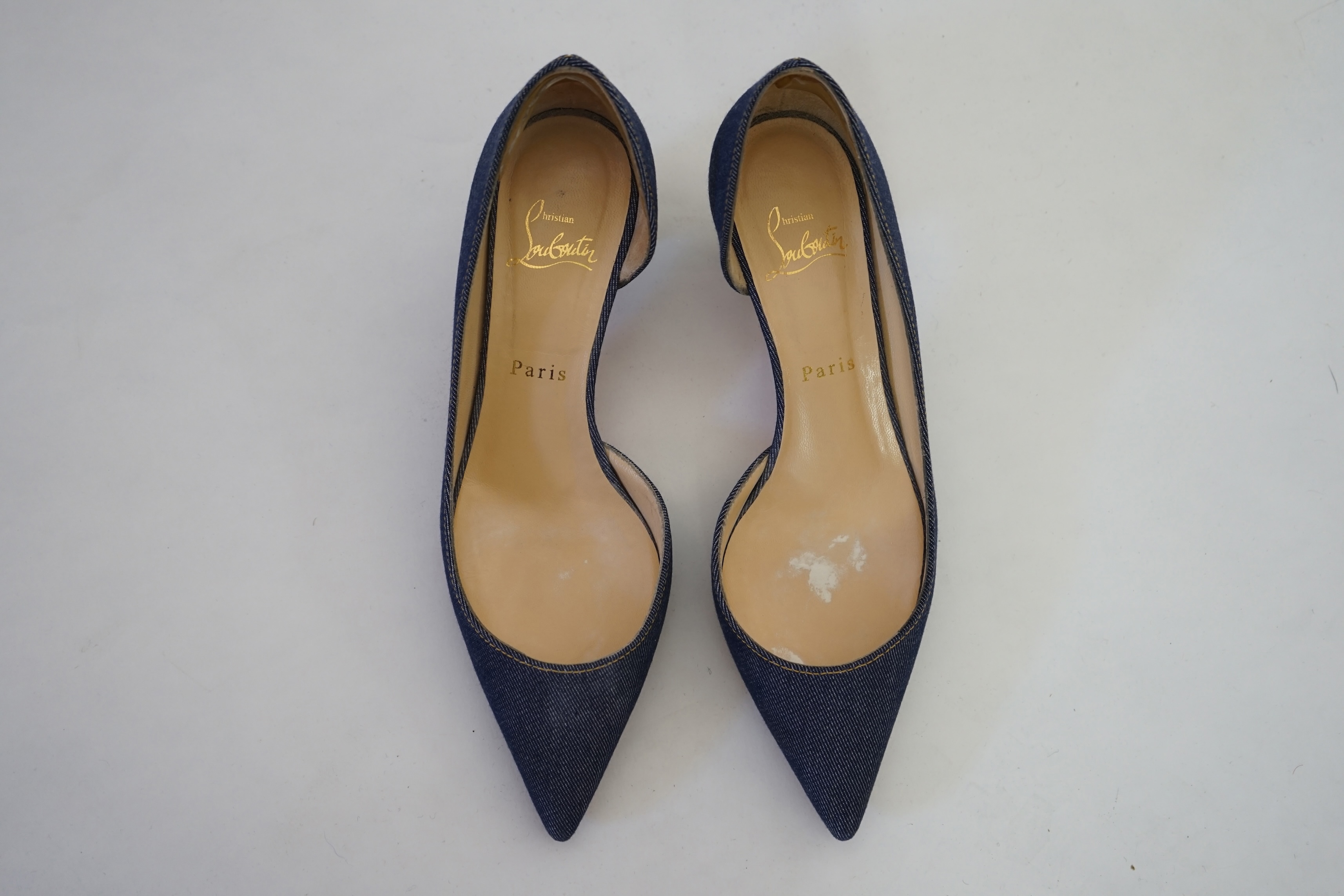 A pair of Christian Louboutin lady's denim pumps with wooden heels, comes with dust bag in original box. Size 39. Proceeds to Happy Paws Puppy Rescue